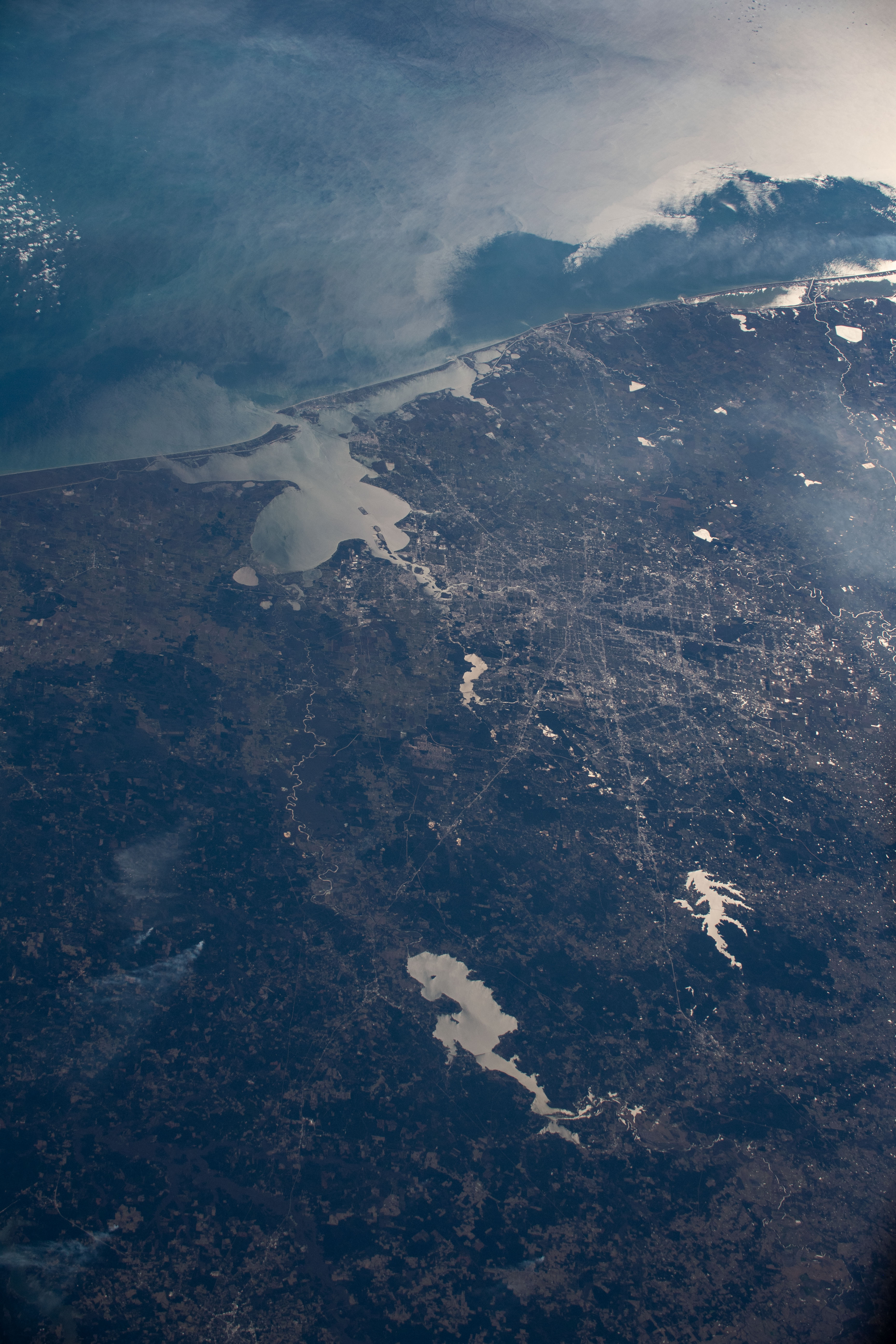 Houston, Texas is pictured from the International Space Station at an altitude of 257 miles. The bodies of water (from top to bottom) are the Gulf of Mexico, Galveston Bay, Lake Houston, Lake Conroe and Lake Livingston.