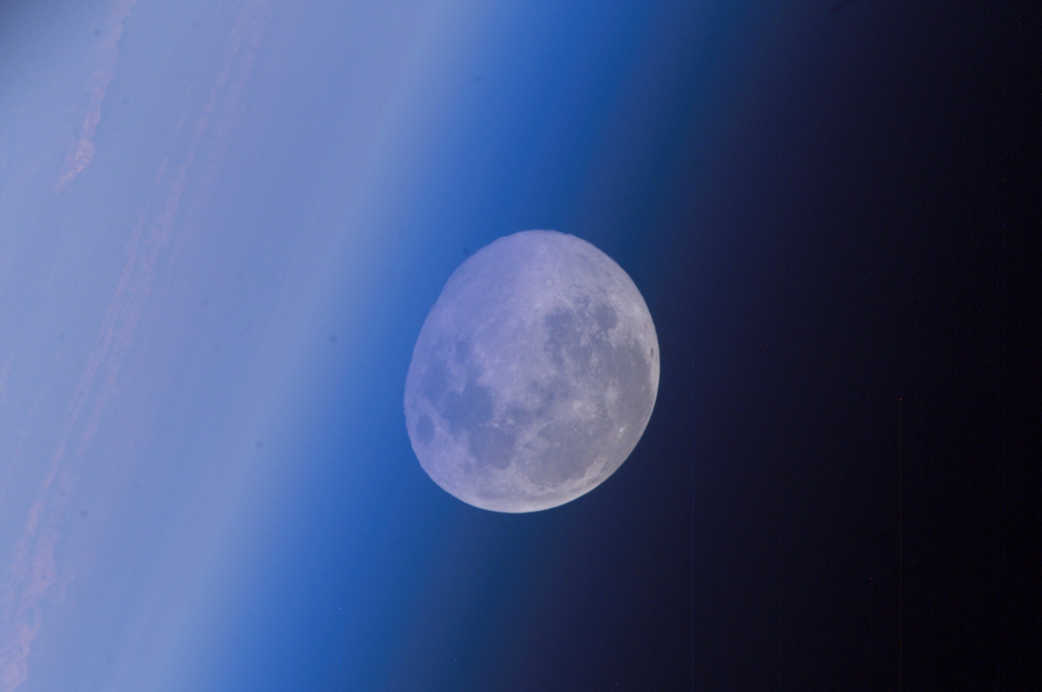 This distorted view of a full moon intersecting Earth's horizon was photographed by an Expedition 14 crewmember onboard the International Space Station.