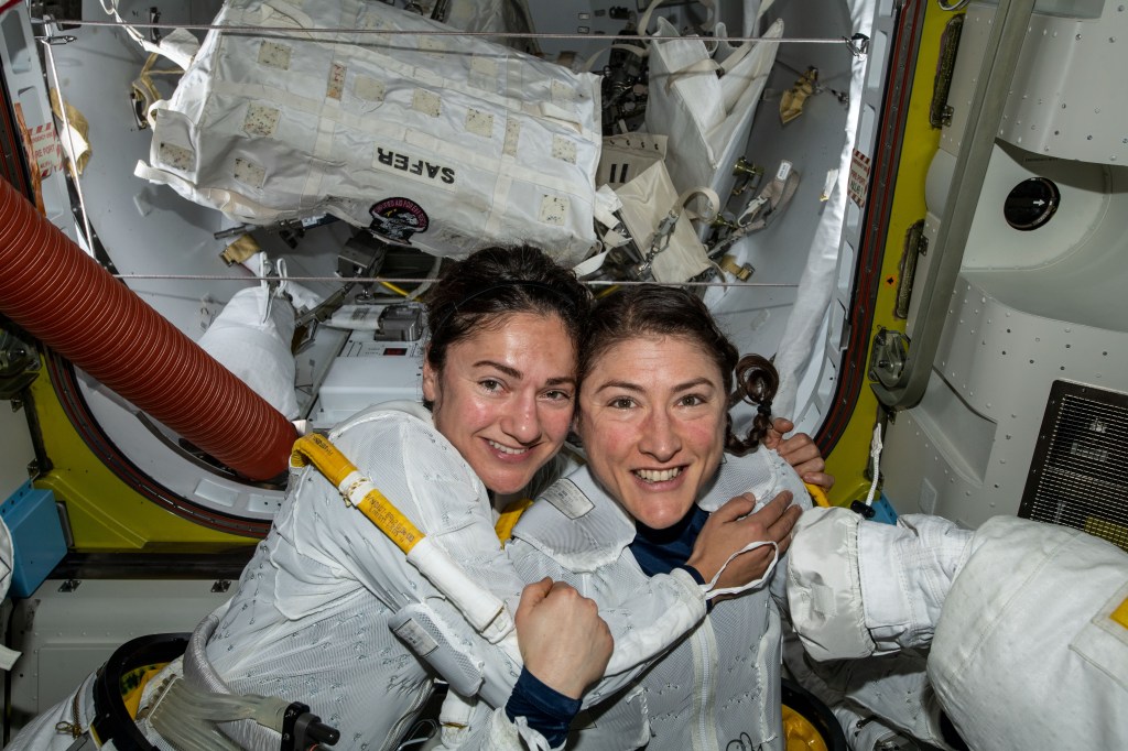 NASA astronauts Jessica Meir (left) and Christina Koch (right) to prepare to leave the hatch of the International Space Station and begin the historic first-ever all-female spacewalk.