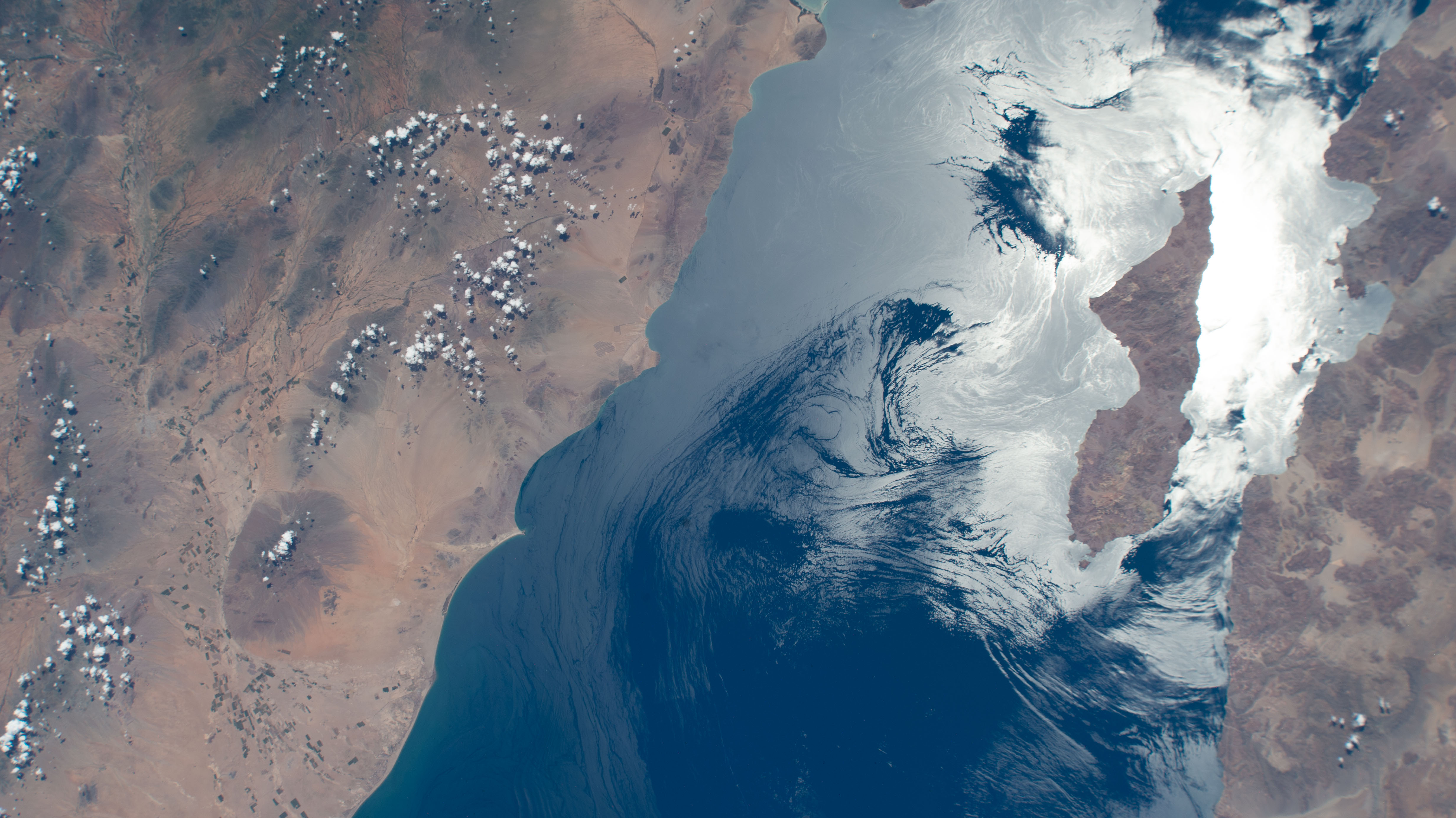 The sun's glint beam's off of the Gulf of California highlighting Archangel Island, which is part of the Mexican state of Baja California, in this photograph from the International Space Station as it orbited 258 miles above.