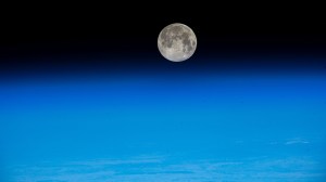 The near Full Moon is pictured just above Earth's atmosphere in this photograph from the International Space Station as it orbited 262 miles above the Pacific Ocean off the coast of Japan.
