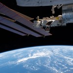 A set of the International Space Station's main solar arrays, slightly obscuring the smaller roll-out solar arrays, and the Kibo laboratory module with its exposed facility, a research platform that hosts external experiments, are pictured 261 miles above the Pacific Ocean.