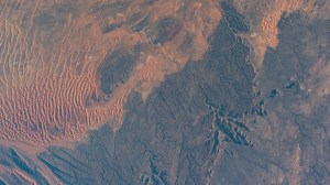 Sand dunes, sandstone plateaus, and rocky platforms that comprise the Tassili N'Ajjer National Park in the southeastern portion of Algeria are pictured from the International Space Station as it orbited 261 mile above the Sahara.