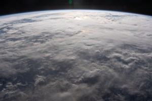 A cloud-covered Indian Ocean, illuminated about an hour before sunset, is pictured from the International Space Station as it orbited 260 miles above just off the northeast coast of the island nation of Madagascar.