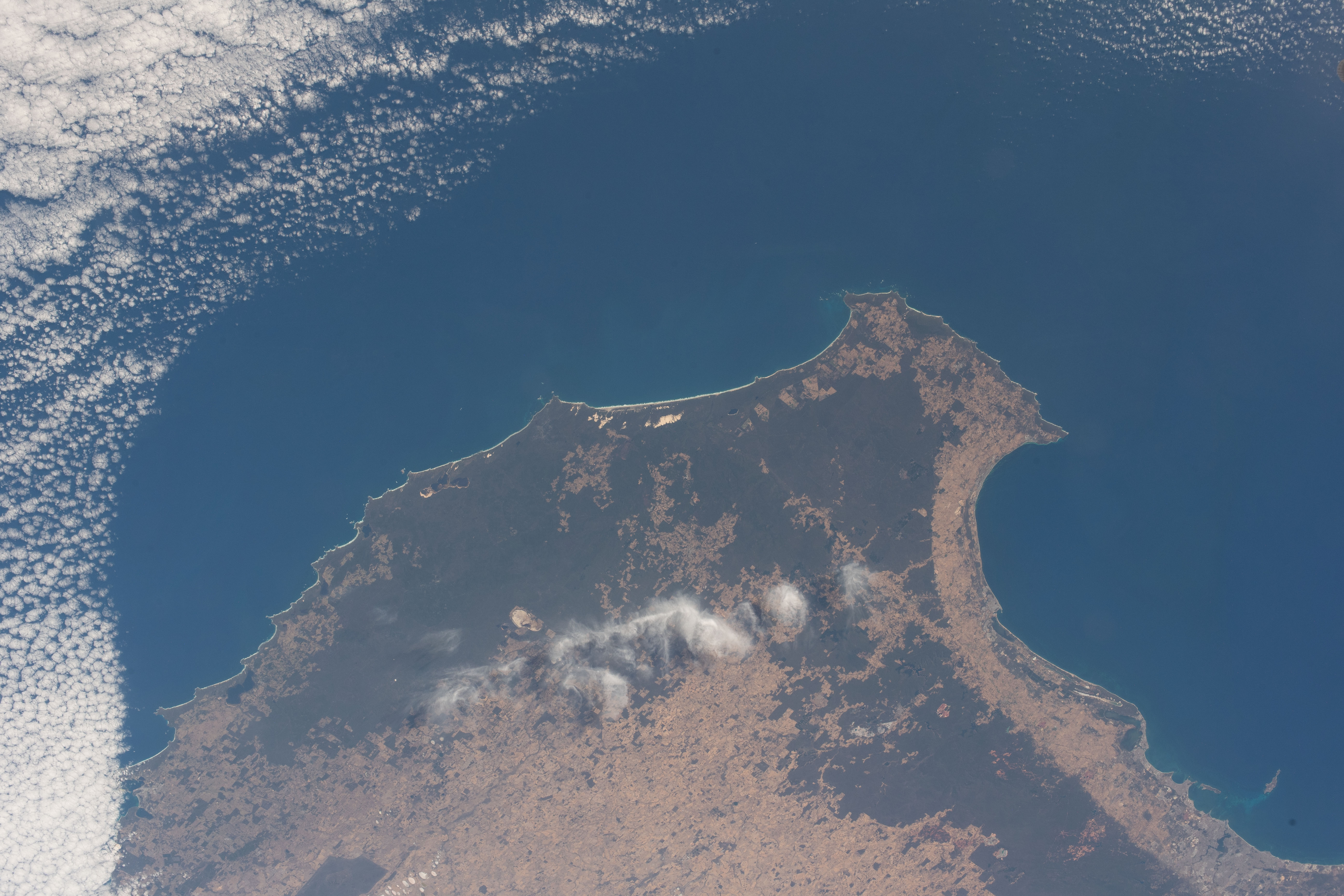 The southwestern tip of Western Australia, with its capital city of Perth at bottom right, is pictured from the International Space Station as it orbited 265 miles above the Indian Ocean off the coast of the island continent.