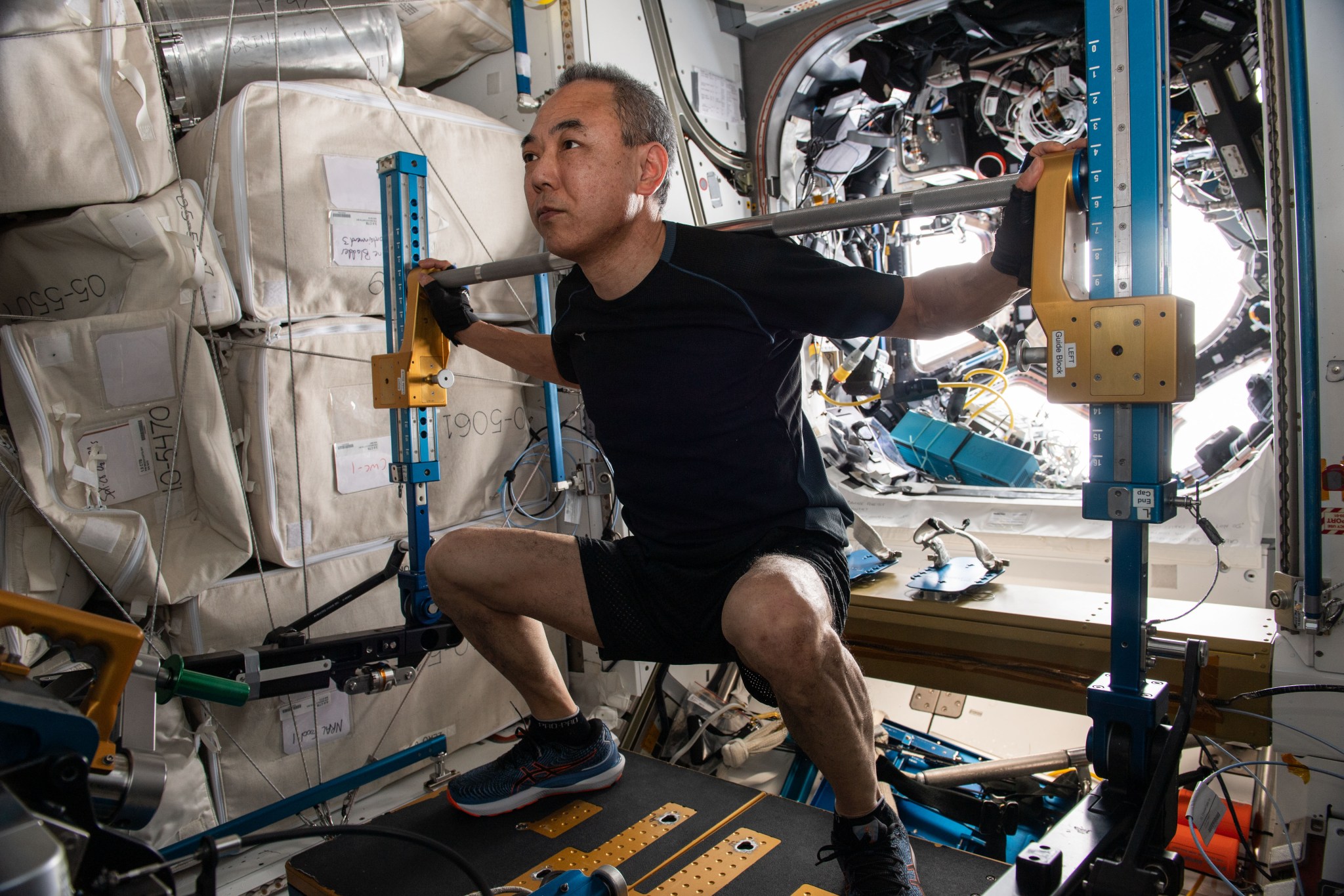 Expedition 70 Flight Engineer and JAXA (Japan Aerospace Exploration Agency) astronaut Satoshi Furukawa works out on the Advanced Resisitive Exercise Device located (ARED) in the International Space Station's Tranquility module. The ARED is designed to mimic the inertial forces generated when lifting free weights on Earth.