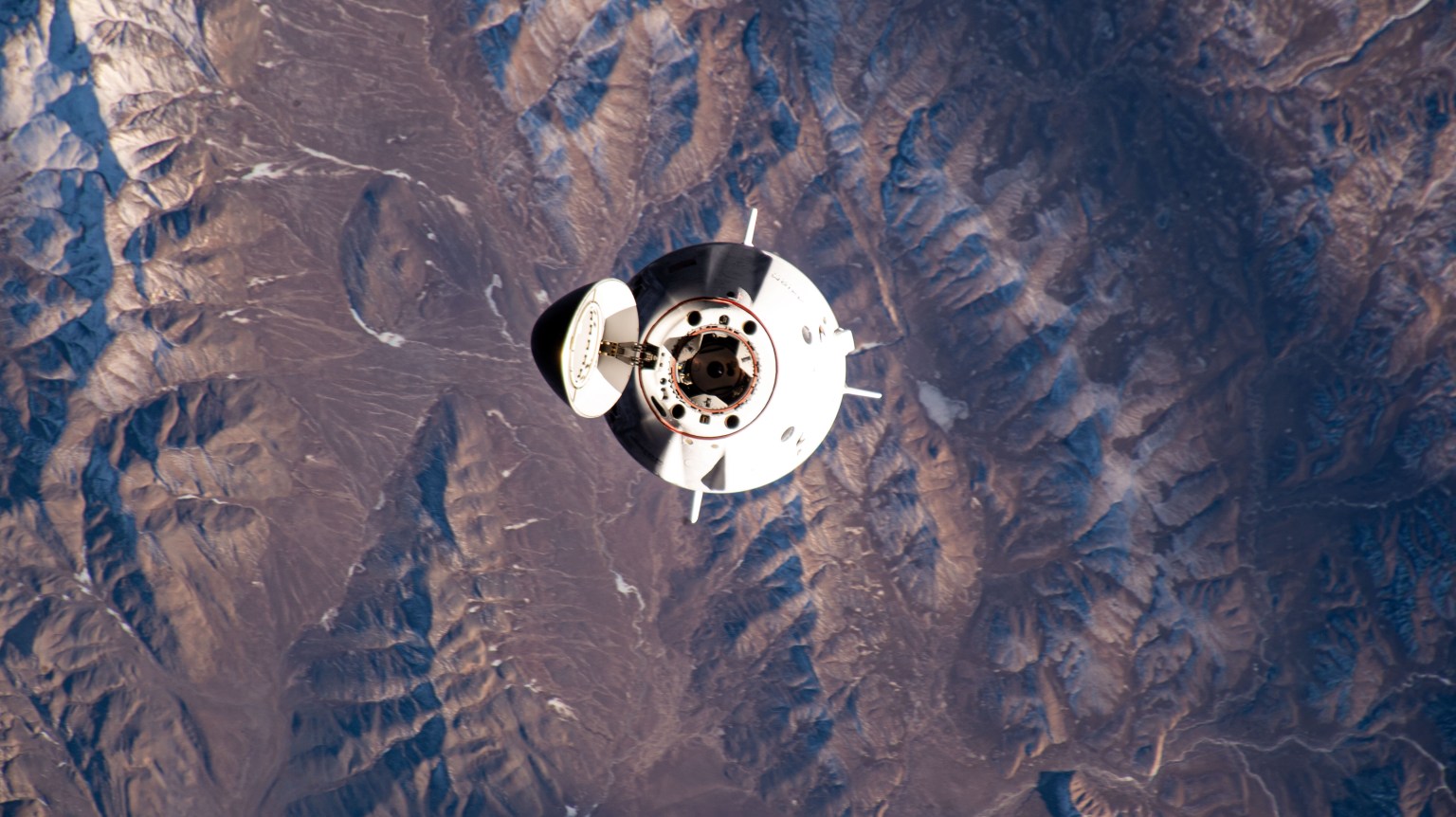 The SpaceX Dragon Freedom spacecraft carrying the four-member Axiom Mission 3 (Ax-3) crew is pictured approaching the International Space Station 260 miles above China north of the Himalayas.