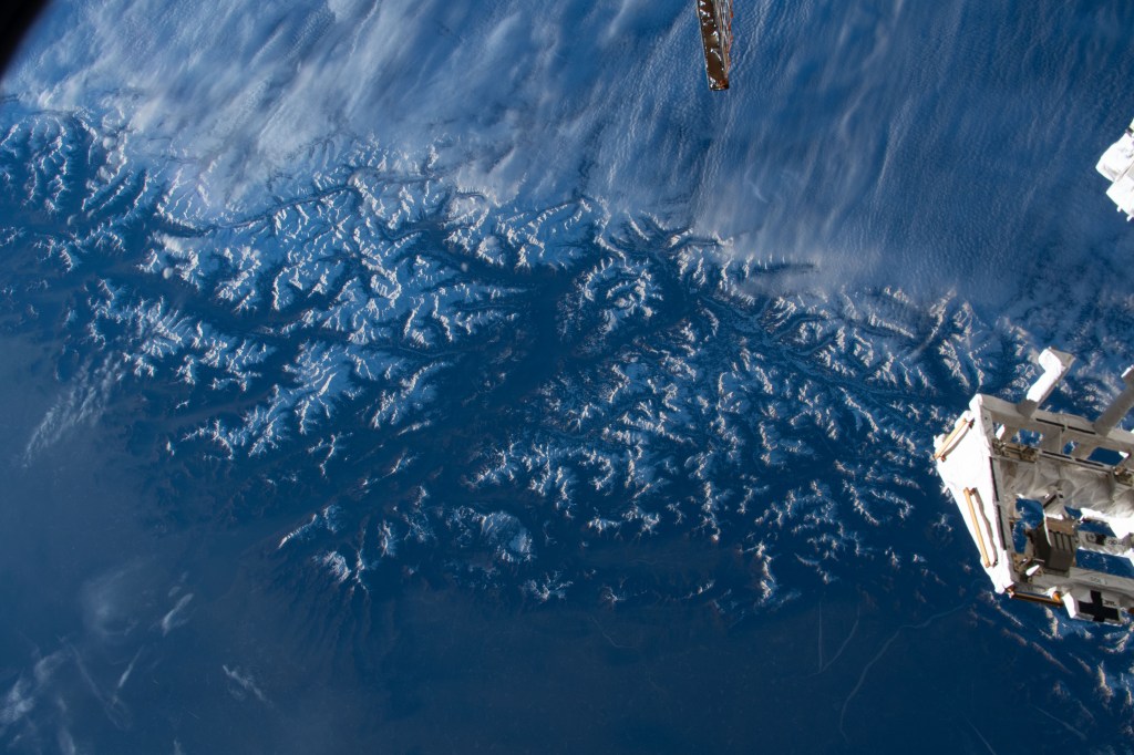 Clouds stop on the peaks of the snow-capped Alps that separate Italy's Po Valley from Austria in this photograph from the International Space Station as it orbited 261 miles above.