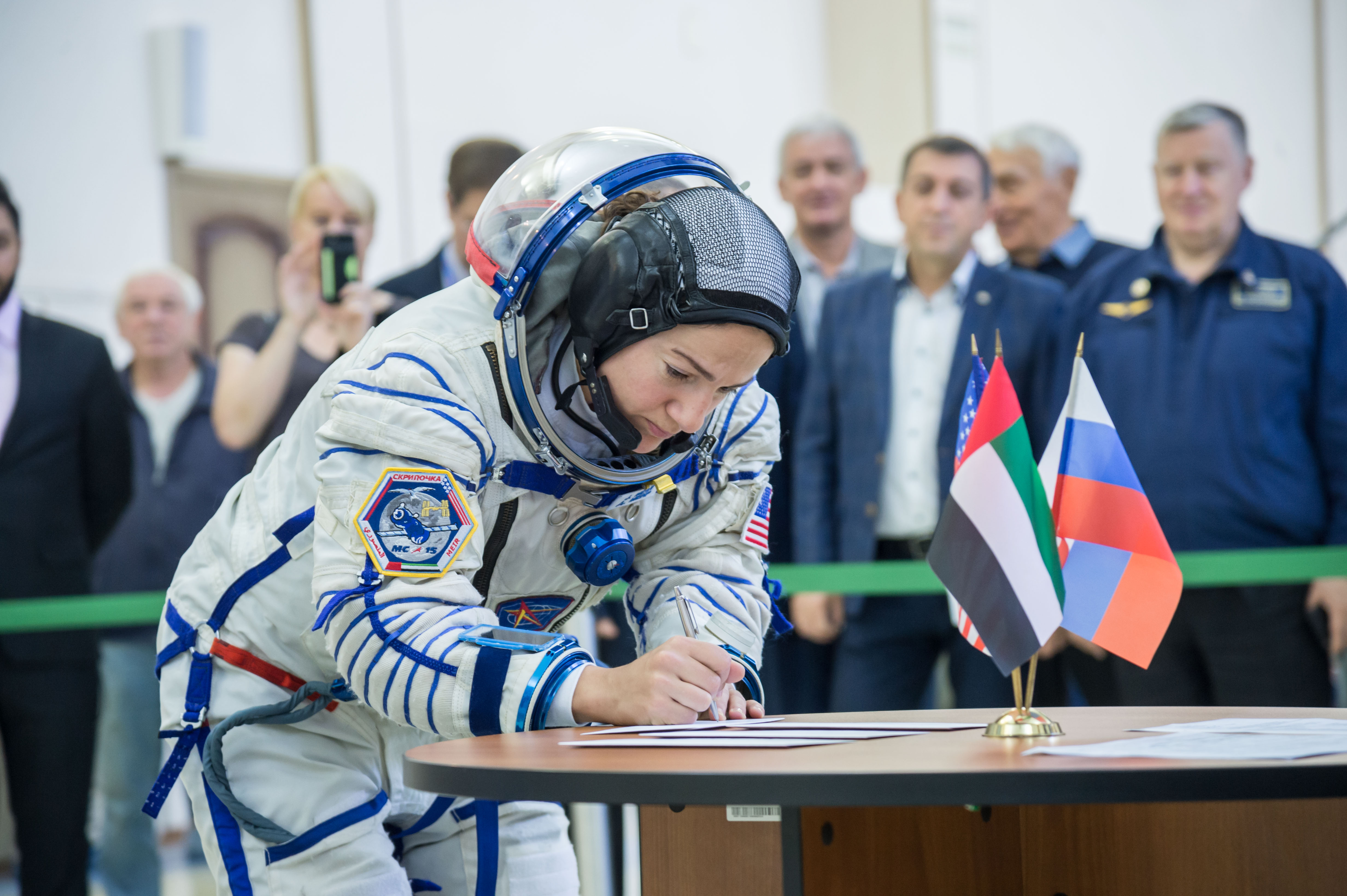 At the Gagarin Cosmonaut Training Center in Star City, Russia, Expedition 61 crewmember Jessica Meir of NASA signs in for the second day of crew qualification exams Aug. 30. Along with Expedition 61 crewmember Oleg Skripochka of Roscosmos and spaceflight participant Hazzaa Ali Almansoori of the United Arab Emirates, Meir will launch Sept. 25 on the Soyuz MS-15 spacecraft from the Baikonur Cosmodrome in Kazakhstan for a mission on the International Space Station.