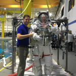 Kyle Ellis, project manager in the Aeronautics Research Directorate at NASA’s Langley Research Center in Hampton, Virginia, gives the thumbs up next to a man in an astronaut training suit