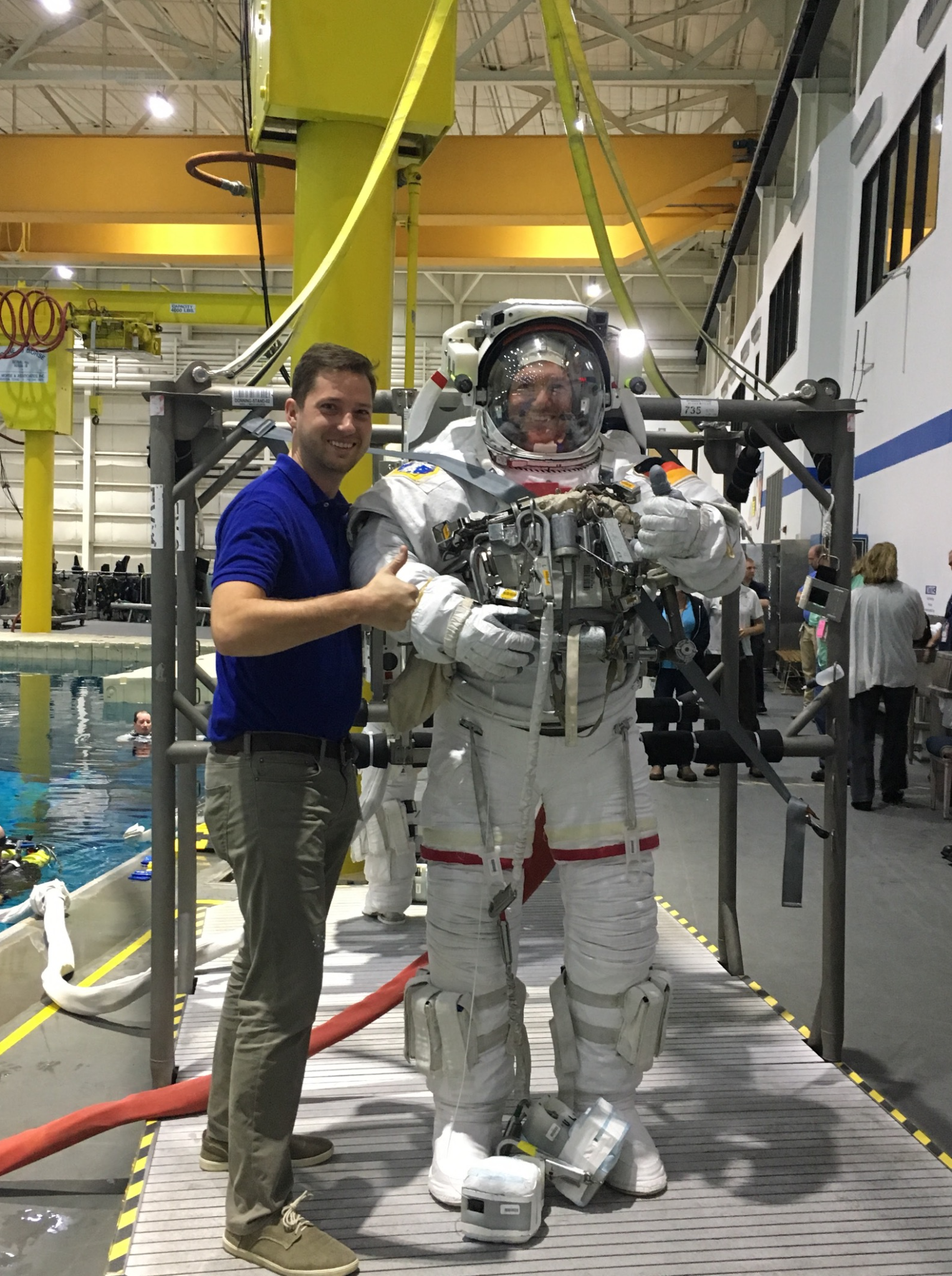 Kyle Ellis, project manager in the Aeronautics Research Directorate at NASA’s Langley Research Center in Hampton, Virginia, gives the thumbs up next to a man in an astronaut training suit 