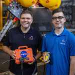 Cody Kelly and Thomas Montano from the Goddard Search and Rescue team showcasing the ANGEL beacons during Artemis testing.