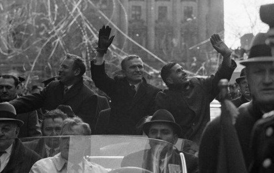 Apollo 8 astronauts James A. Lovell, left, Frank Borman, and William A. Anders wave to the crowds assembled along their parade route in New York City