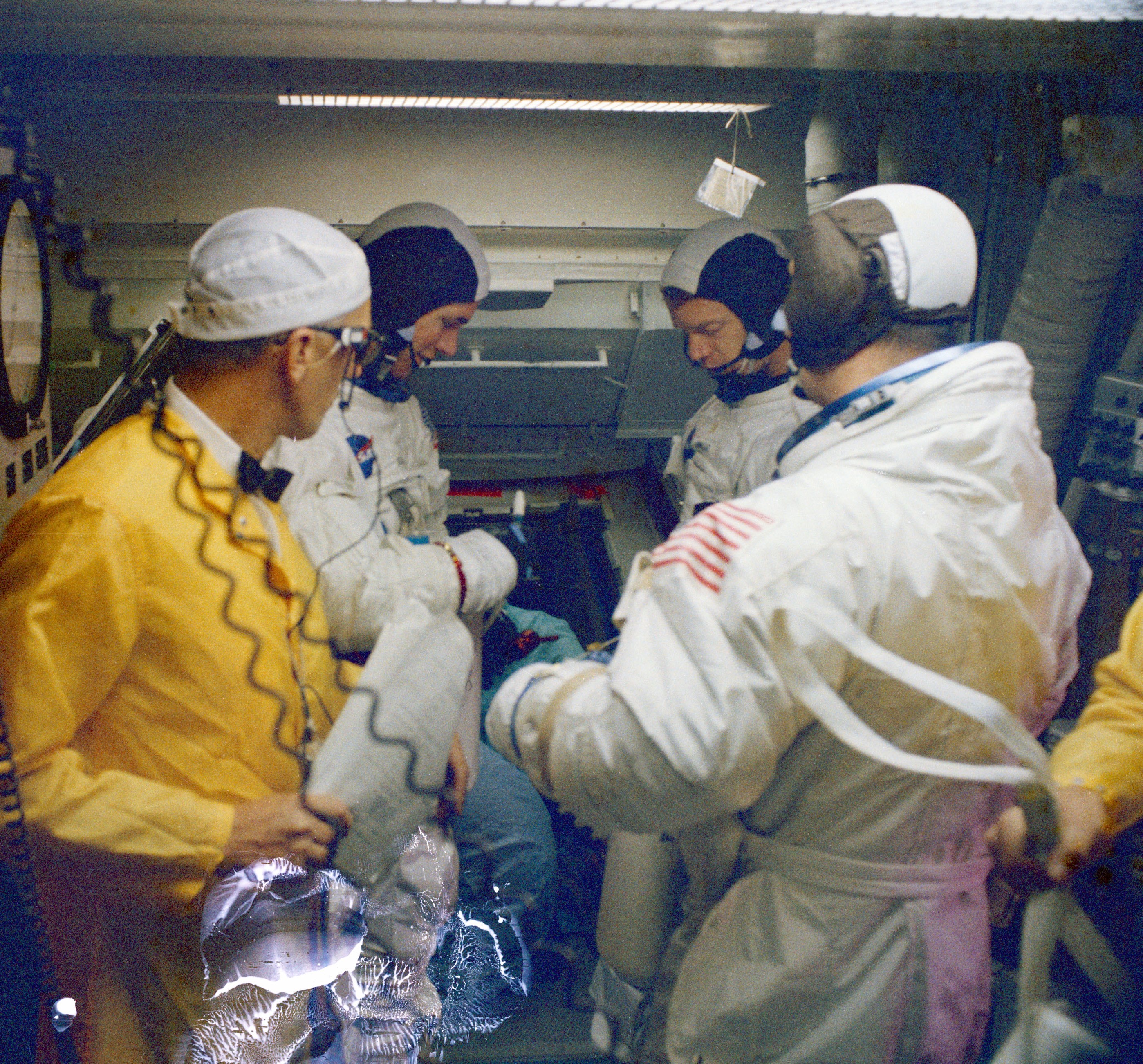Scott, left, Schweickart, and McDivitt in the White Room during the pad emergency escape drill