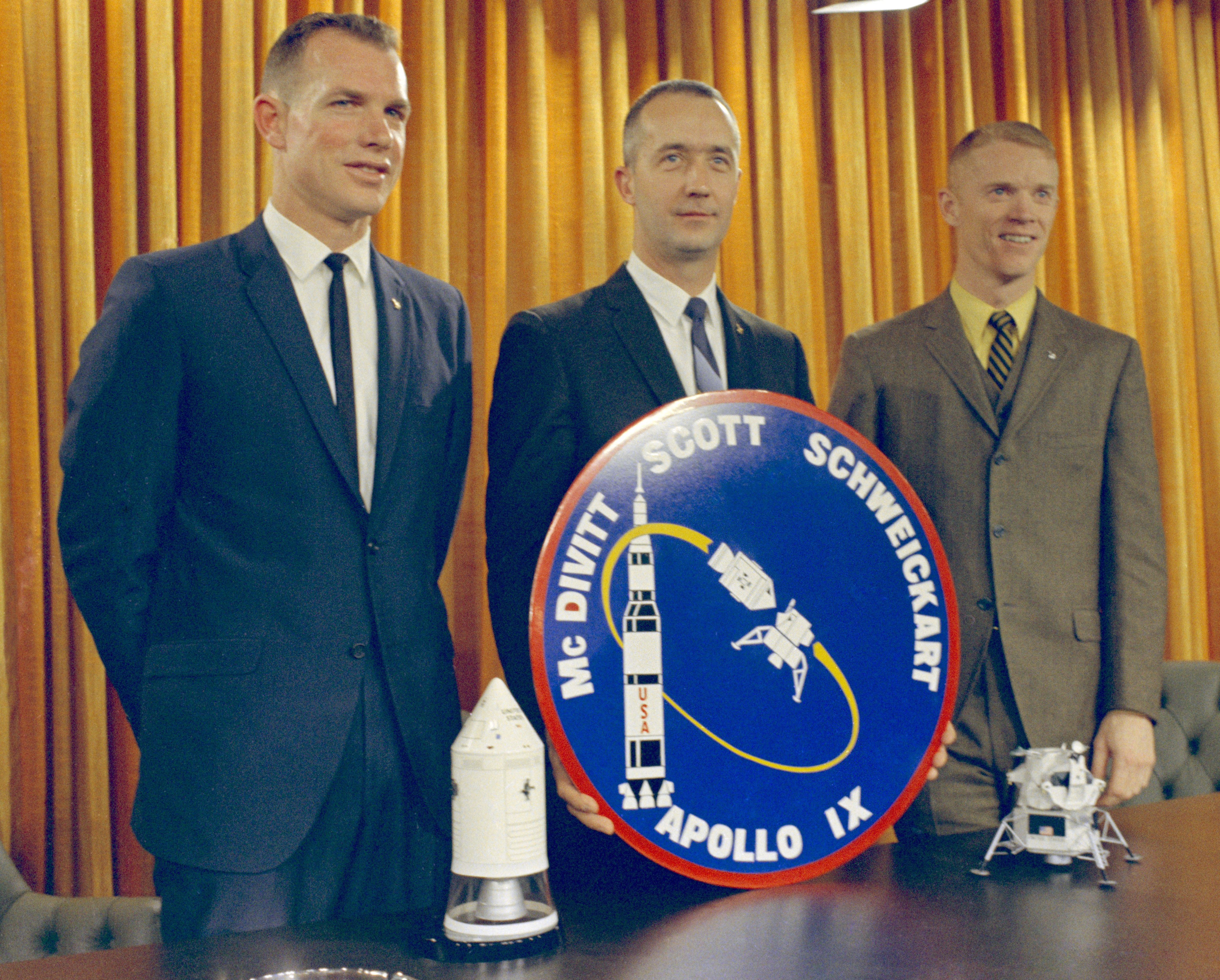 Scott, left, McDivitt, and Schweickart pose with their mission patch following a press conference at Grumman Aircraft and Engineering Corporation in Bethpage, New York