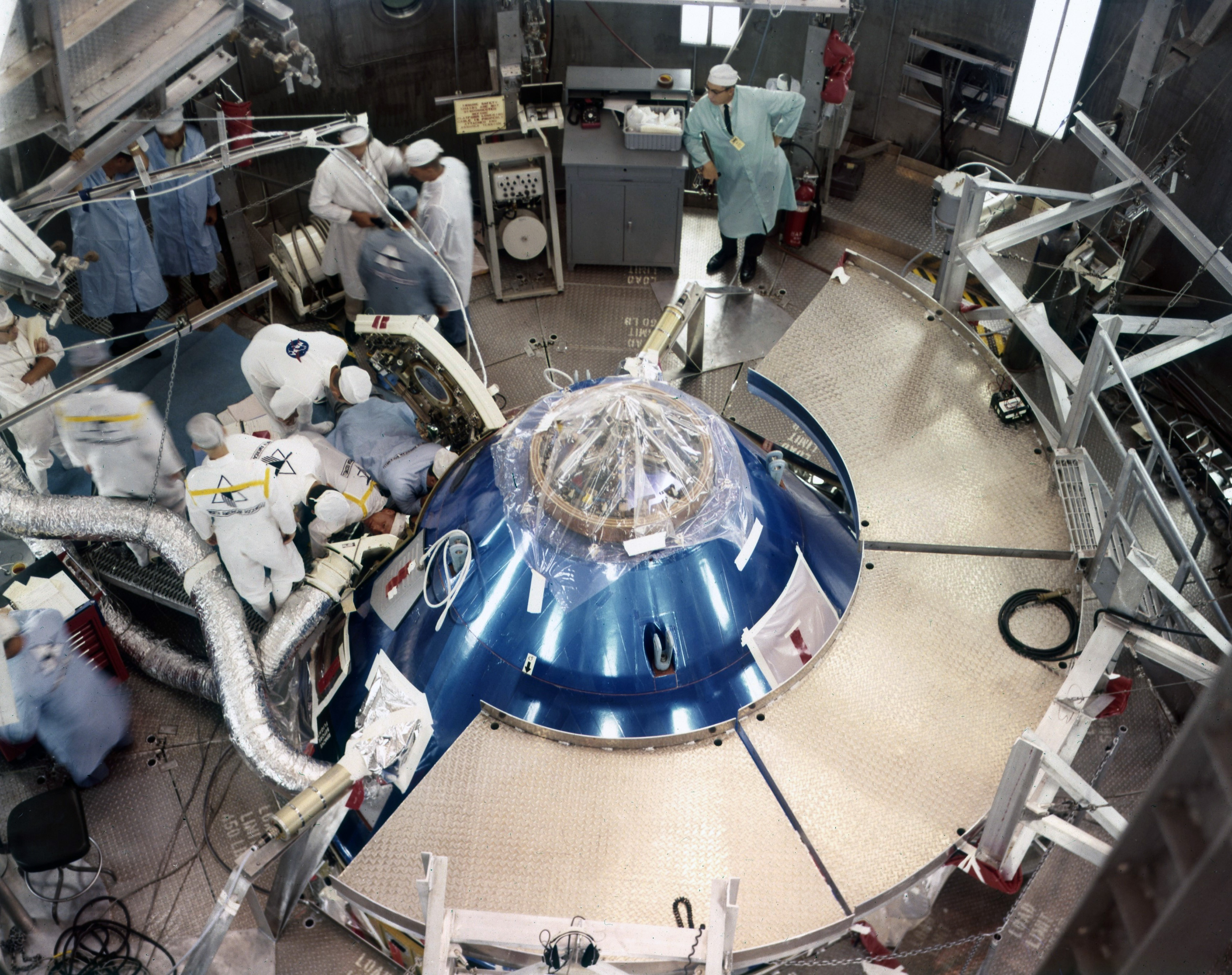 Engineers prepare the CM for an altitude test
