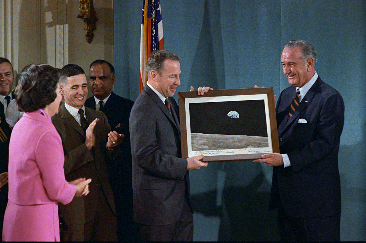At the White House, Apollo 8 astronauts Frank Borman, James A. Lovell, and William A. Anders present a copy of the Earthrise photograph to President Lyndon B. Johnson