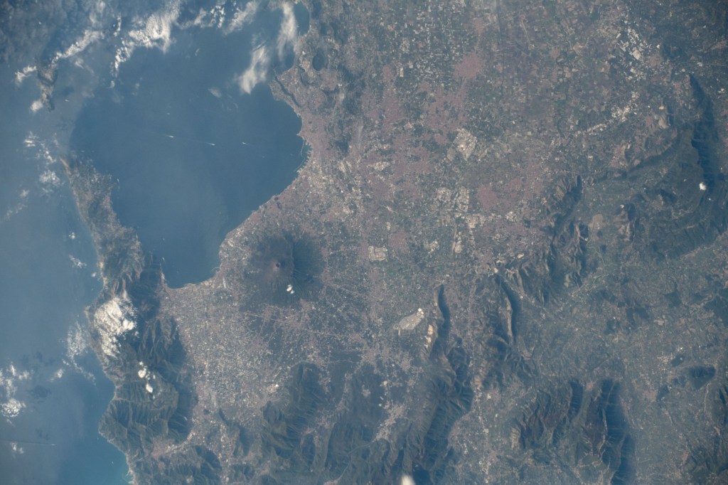 Mount Vesuvius rests in between the Italian cities of Naples and Pompei on the southwest coast of Italy with three million people living in the region. The International Space Station was orbiting 255 miles above the Tyrrhenian Sea between Italy and its island of Sardegna when an Expedition 61 crewmember took this photograph.