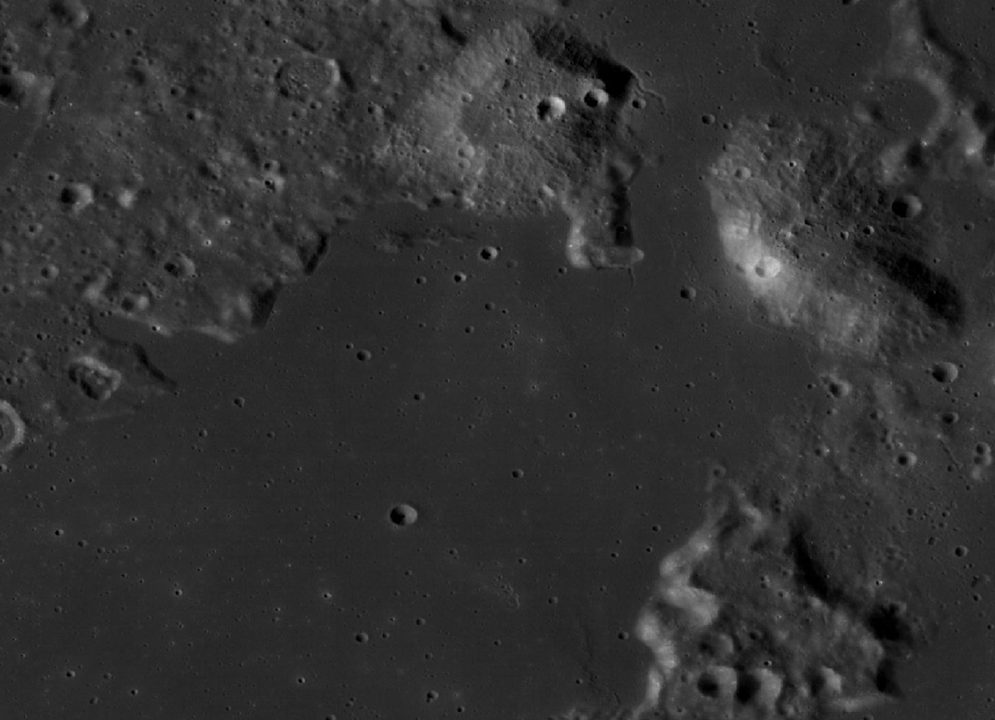 This image of Sinus Viscositatis, a large flat region that was once a giant lava flow near the Gruithuisen Domes, shows where Astrobotic’s Peregrine One lander will touch down. The image is a mosaic taken by the WAC (Wide Angle Camera) one of three cameras on the LROC (Lunar Reconnaissance Orbiter Camera), which was launched into lunar orbit in 2009.