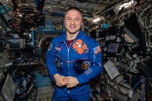 NASA astronaut Andrew Morgan, who is also a medical doctor in the U.S. Army, displays his Brooke Army Medical Center Commander’s Coin aboard the International Space Station.