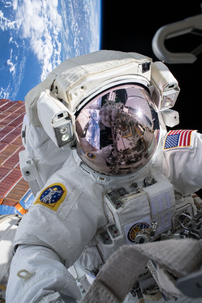 NASA astronaut Andrew Morgan conducts a spacewalk at the Port- 6 (P6) truss structure work site to upgrade International Space Station power systems. He was photographed by fellow NASA astronaut Christina Koch as they worked outside in the vacuum of space for seven hours and one minute to begin the latest round of upgrading the station's large nickel-hydrogen batteries with newer, more powerful lithium-ion batteries.