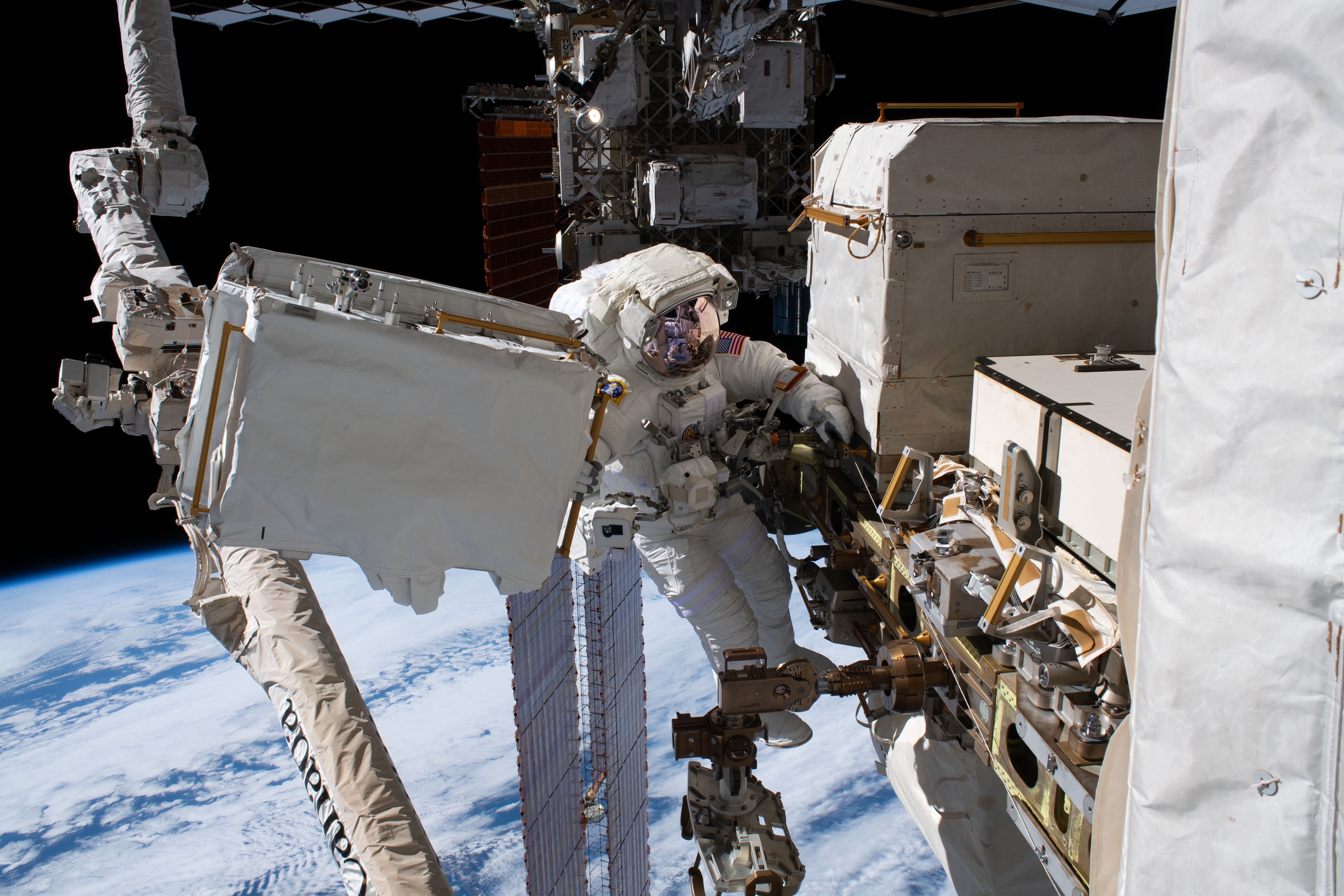 NASA astronaut Andrew Morgan is tethered to the International Space Station with the Earth 250 miles below during the third spacewalk to upgrade the Alpha Magnetic Spectrometer's thermal pump system.