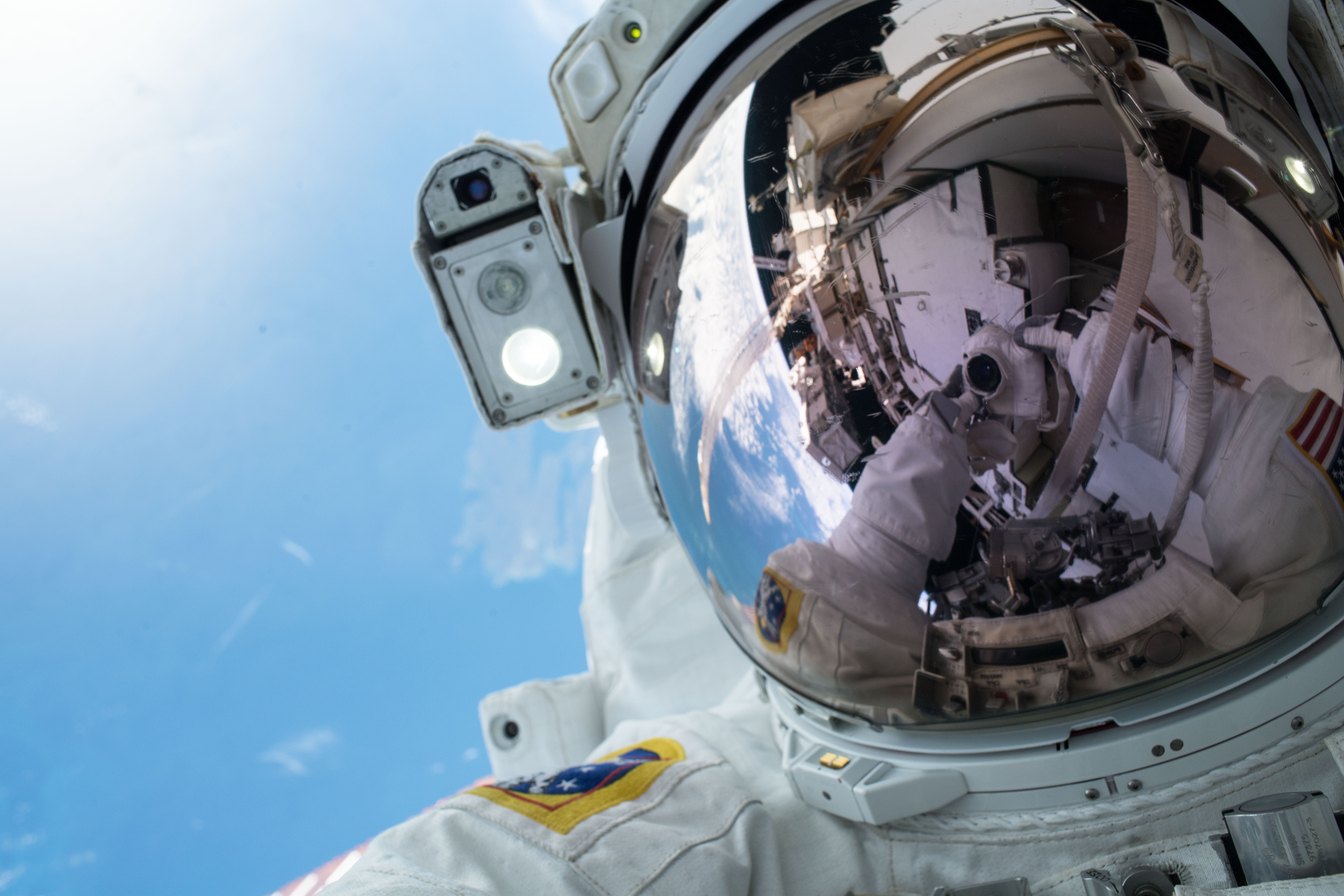 NASA astronaut Andrew Morgan takes an out-of-this-world "space-selfie" during a spacewalk to upgrade International Space Station power systems on the Port- 6 (P6) truss structure. He and fellow NASA astronaut Christina Koch (out of frame) worked outside in the vacuum of space for seven hours and one minute to begin the latest round of upgrading the station's large nickel-hydrogen batteries with newer, more powerful lithium-ion batteries.