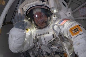 NASA astronaut Andrew Morgan waves from inside the crew lock portion of the Quest airlock where spacewalks in U.S. spacesuits are staged. He would go on to conduct a seven hour and one minute spacewalk with NASA astronaut Christina Koch to begin the latest round of upgrading the station's large nickel-hydrogen batteries with newer, more powerful lithium-ion batteries.