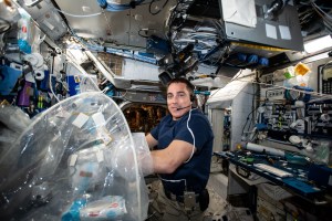 NASA astronaut Chris Cassidy services biological samples in a glovebag for the Food Physiology experiment to characterize the key effects of an enhanced spaceflight diet on immune function, the gut microbiome, and nutritional status indicators.