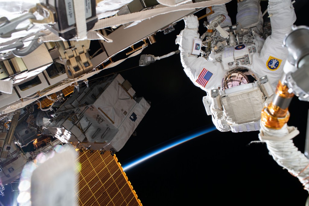 NASA astronaut Chris Cassidy works during a six-hour spacewalk to install three lithium-ion batteries on the International Space Station's truss structure. The orbiting lab was above the North Pacific Ocean off the coast of Russia flying into an orbital sunrise at the time this photograph was taken.