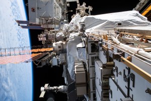 NASA astronaut Christina Koch (top center) conducts a spacewalk at the Port-6 (P6) truss structure work site to upgrade International Space Station power systems. She and fellow NASA astronaut Andrew Morgan (out of frame) worked outside in the vacuum of space for seven hours and one minute to begin the latest round of upgrading the station's large nickel-hydrogen batteries with newer, more powerful lithium-ion batteries.