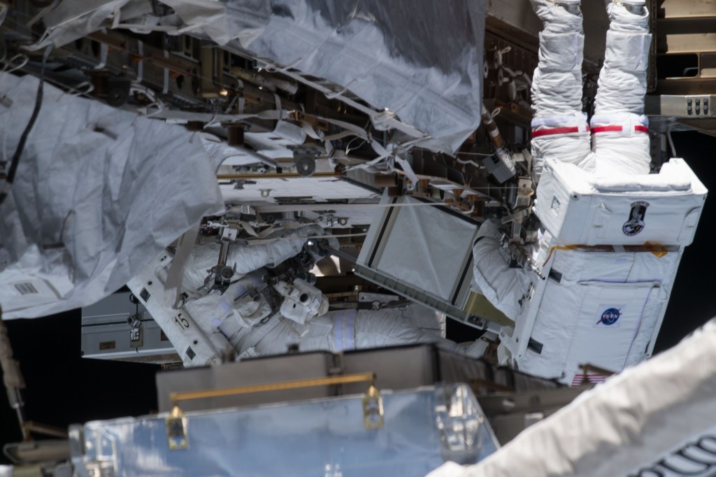 NASA astronaut Christina Koch (right) conducts a spacewalk at the Port-6 (P6) truss structure work site to upgrade International Space Station power systems. She and fellow NASA astronaut Andrew Morgan (left) worked outside in the vacuum of space for seven hours and one minute to begin the latest round of upgrading the station's large nickel-hydrogen batteries with newer, more powerful lithium-ion batteries.