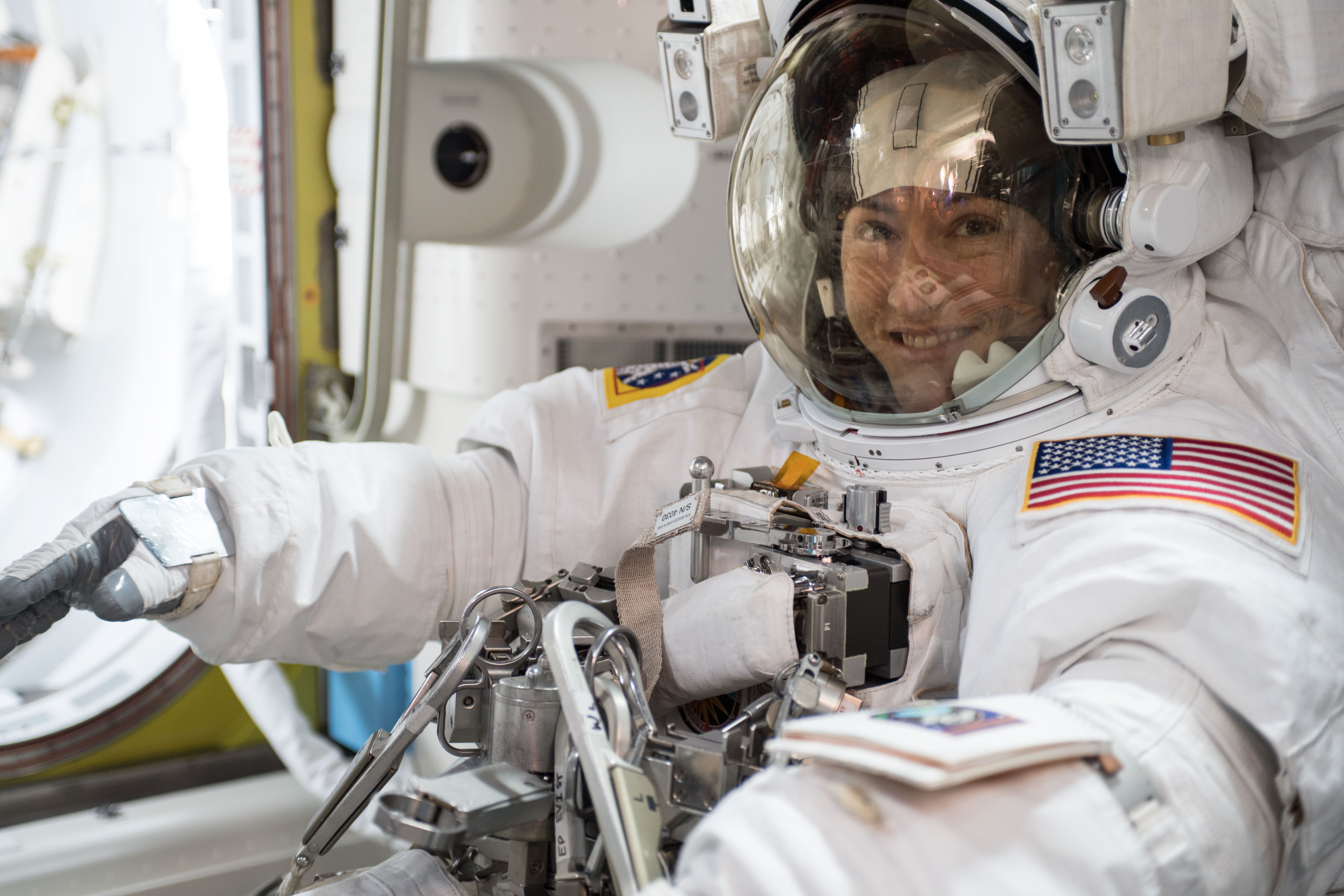 NASA astronaut Christina Koch is suited up in a U.S. spacesuit before beginning a seven hour and one minute spacewalk to upgrade the station's large nickel-hydrogen batteries with newer, more powerful lithium-ion batteries.