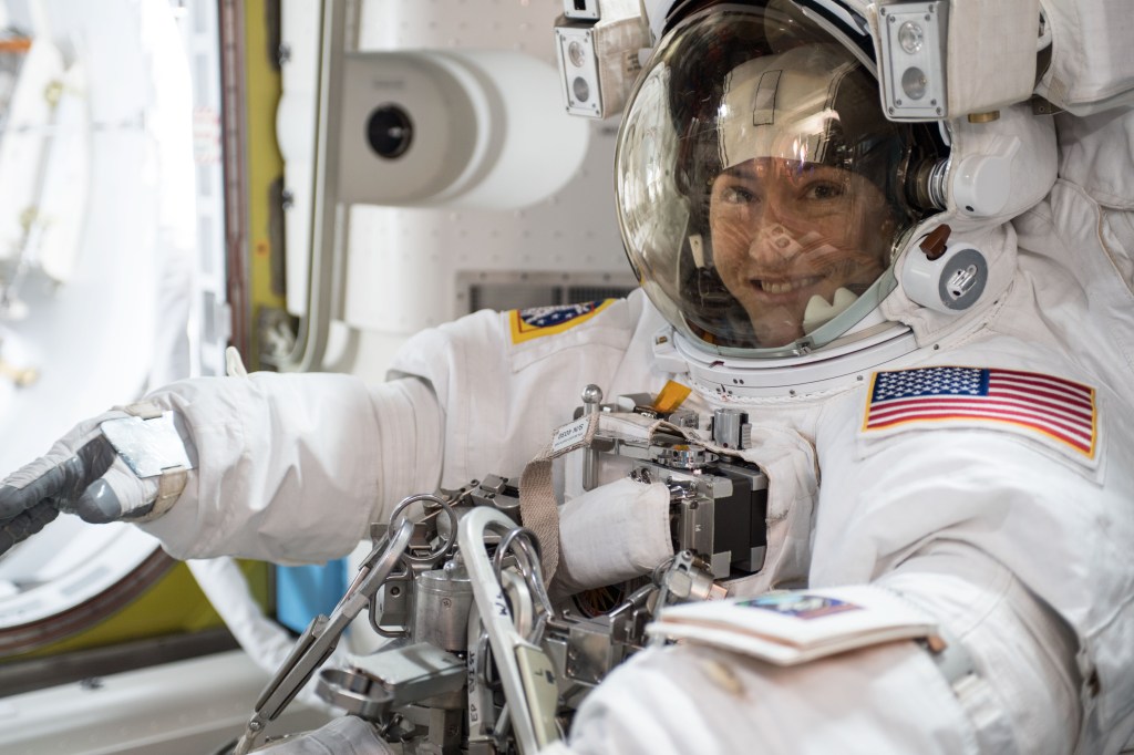 NASA astronaut Christina Koch is suited up in a U.S. spacesuit before beginning a seven hour and one minute spacewalk to upgrade the station's large nickel-hydrogen batteries with newer, more powerful lithium-ion batteries.