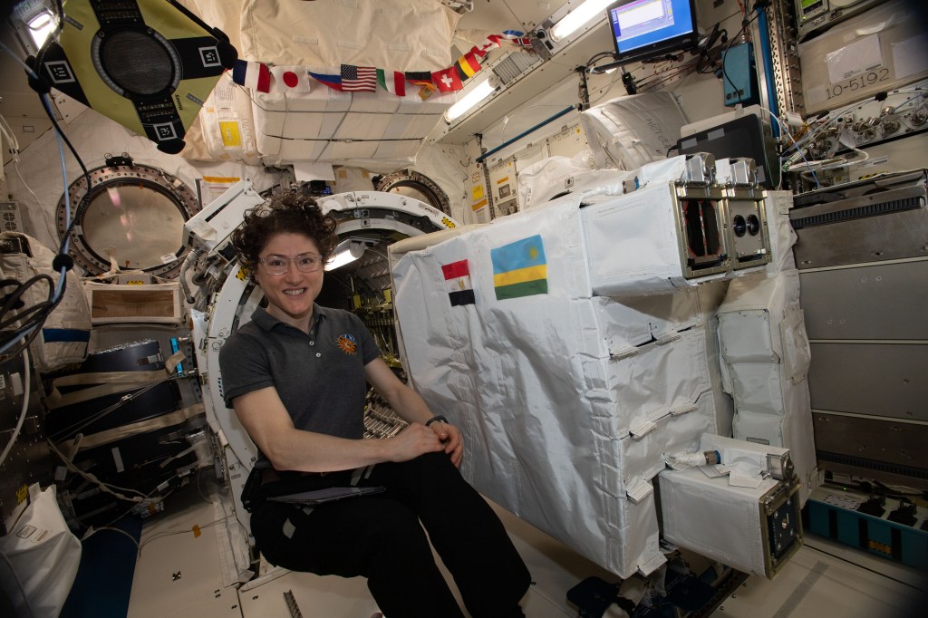 NASA astronaut Christina Koch works inside Japan's Kibo laboratory module setting up a small satellite deployer loaded with three CubeSats developed by the nations of Japan, Rwanda and Egypt. The deployer was placed inside Kibo's airlock before the Japanese robotic arm grappled it and moved it outside Kibo where it would eject all three CubeSats into Earth orbit.