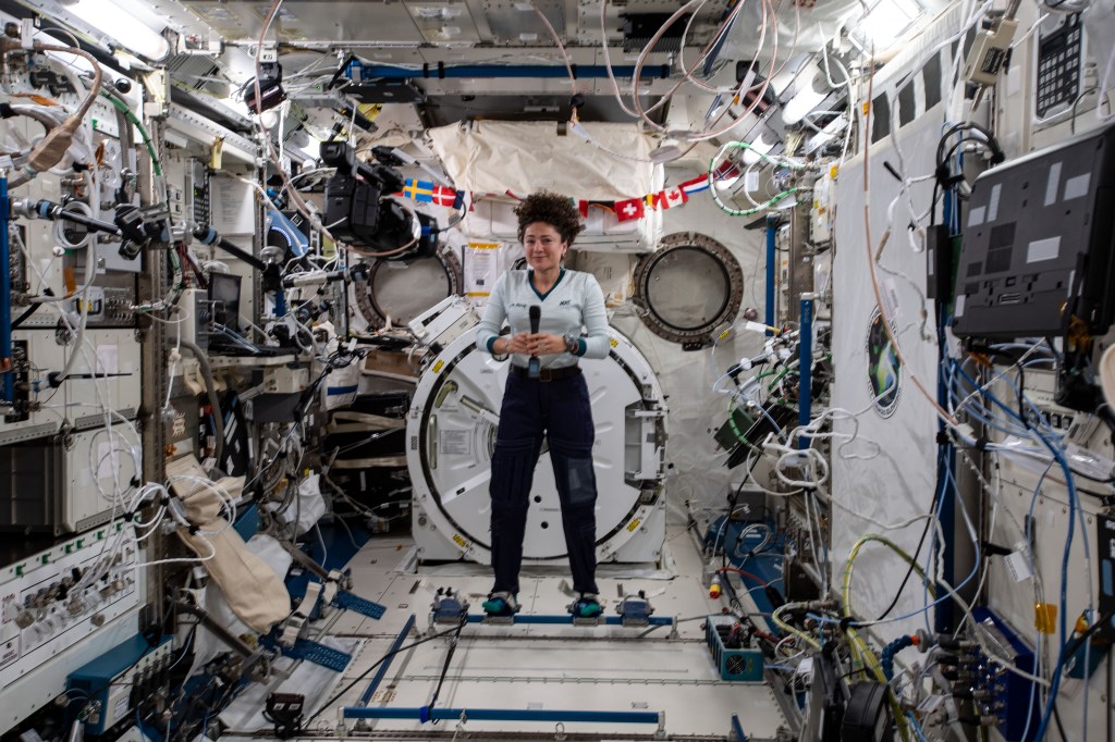 NASA astronaut Jessica Meir, attached to foot restraints inside the Kibo laboratory module from JAXA (Japan Aerospace Exploration Agency), participates in interviews with journalists from Bangor, Maine and Boston, Massachusetts.
