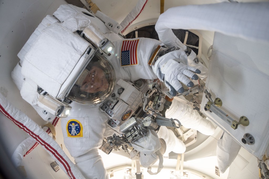 NASA astronaut Jessica Meir is inside the crew lock portion of the U.S. Quest airlock ready to begin her first spacewalk at the International Space Station. She and fellow NASA astronaut Christina Koch (out of frame) would venture into the vacuum of space for seven hours and 17 minutes to swap a failed battery charge-discharge unit (BCDU) with a spare during the first all-woman spacewalk. The BCDU regulates the charge to the batteries that collect and distribute solar power to the orbiting lab’s systems.