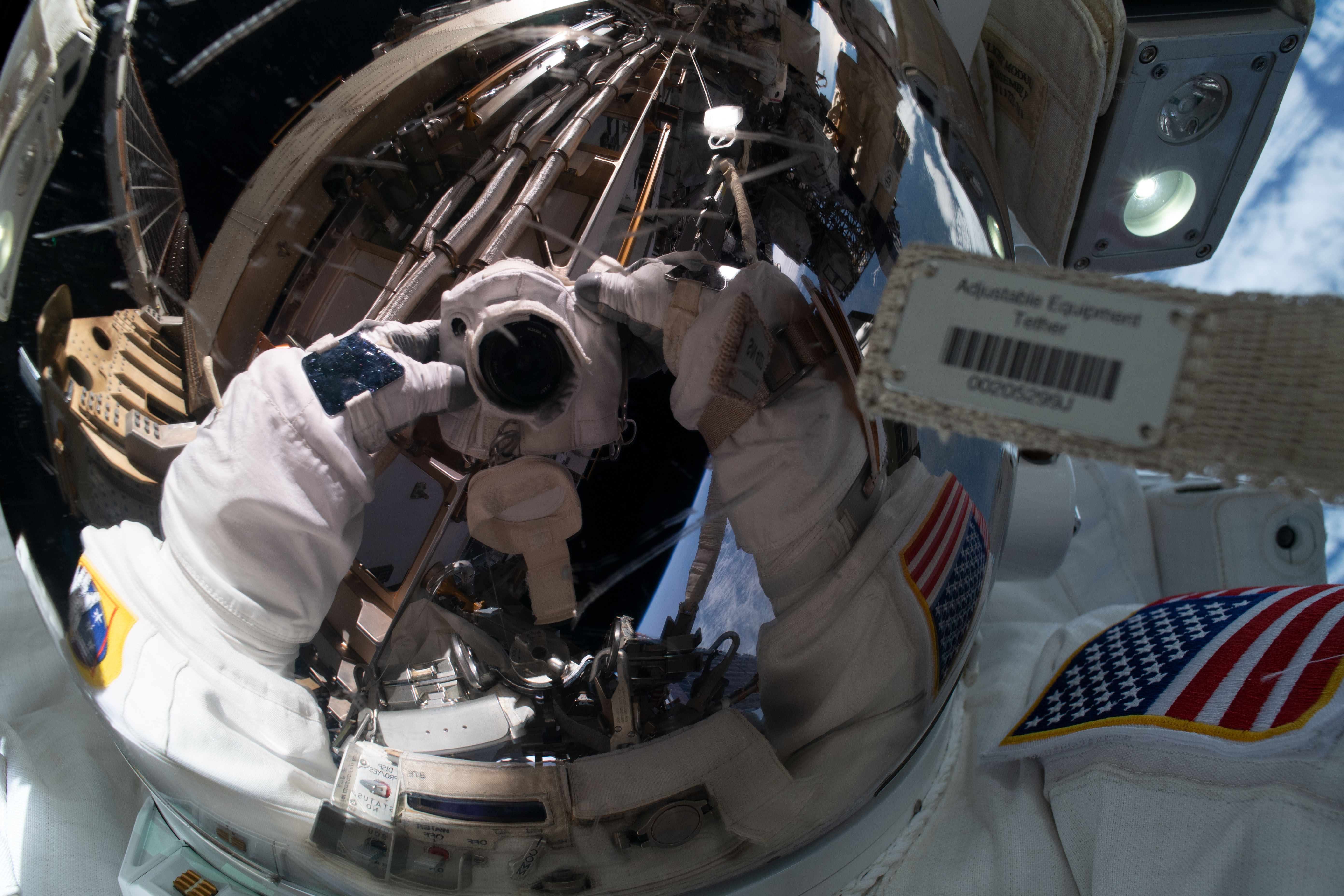 NASA astronaut Jessica Meir takes an out-of-this-world "space-selfie" with her spacesuit helmet visor down reflecting her camera and International Space Station hardware. She and fellow NASA astronaut Christina Koch (out of frame) ventured into the vacuum of space for seven hours and 17 minutes to swap a failed battery charge-discharge unit (BCDU) with a spare during the first all-woman spacewalk. The BCDU regulates the charge to the batteries that collect and distribute solar power to the orbiting lab’s systems.