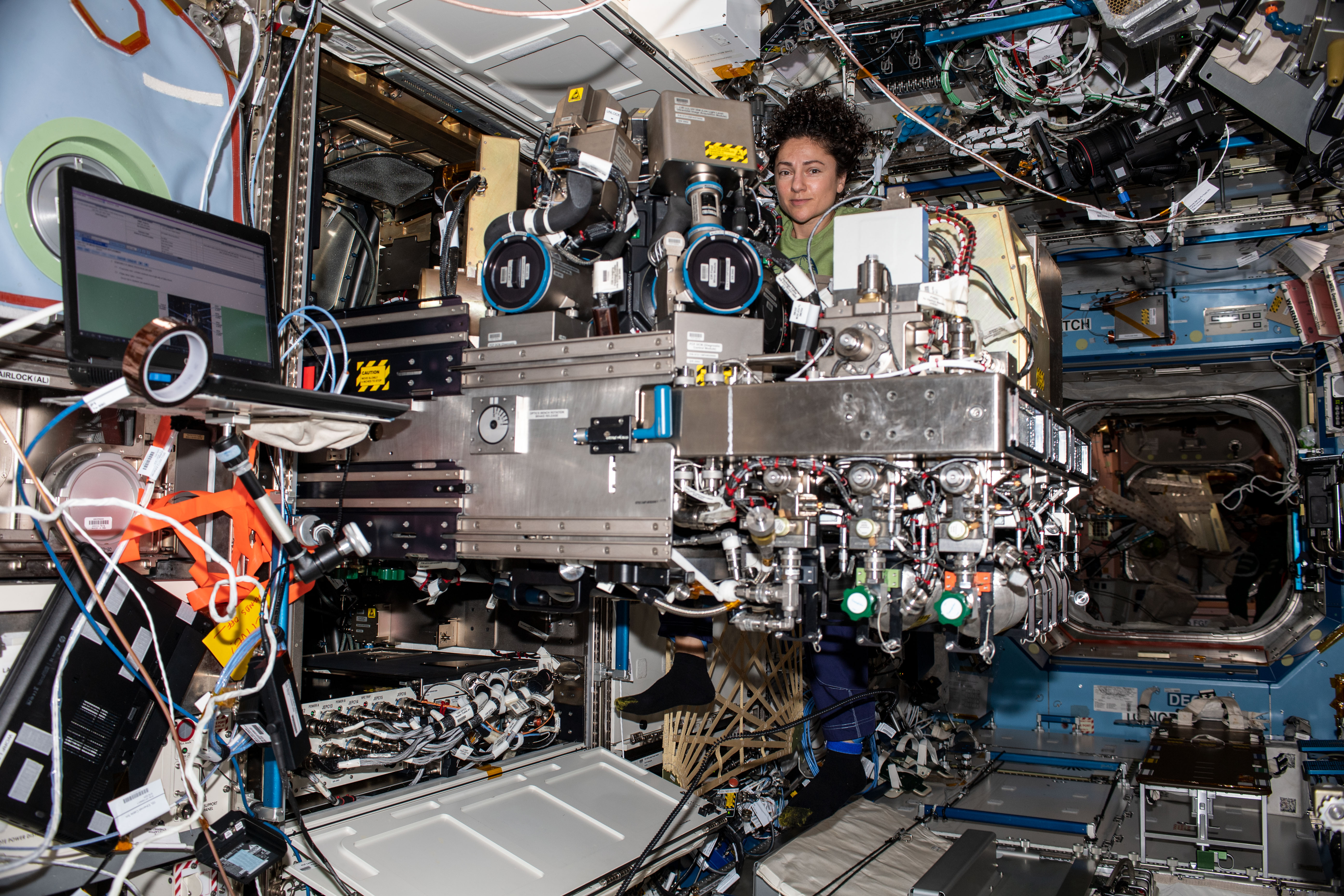 NASA astronaut Jessica Meir of Expedition 61 works on components of the Combustion Integrated Rack aboard the International Space Station's U.S. Destiny laboratory module.