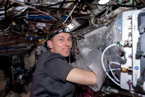 iss068e076275 (March 24, 2021) --- NASA astronaut and Expedition 68 Flight Engineer Woody Hoburg works in a glove bag attached to the BioFabrication Facility (BFF). Hoburg installed a tissue cassette in the BFF to evaluate using bio-inks and cells for a study exploring printing knee cartilage tissue to treat injuries in space and in remote environments on Earth.