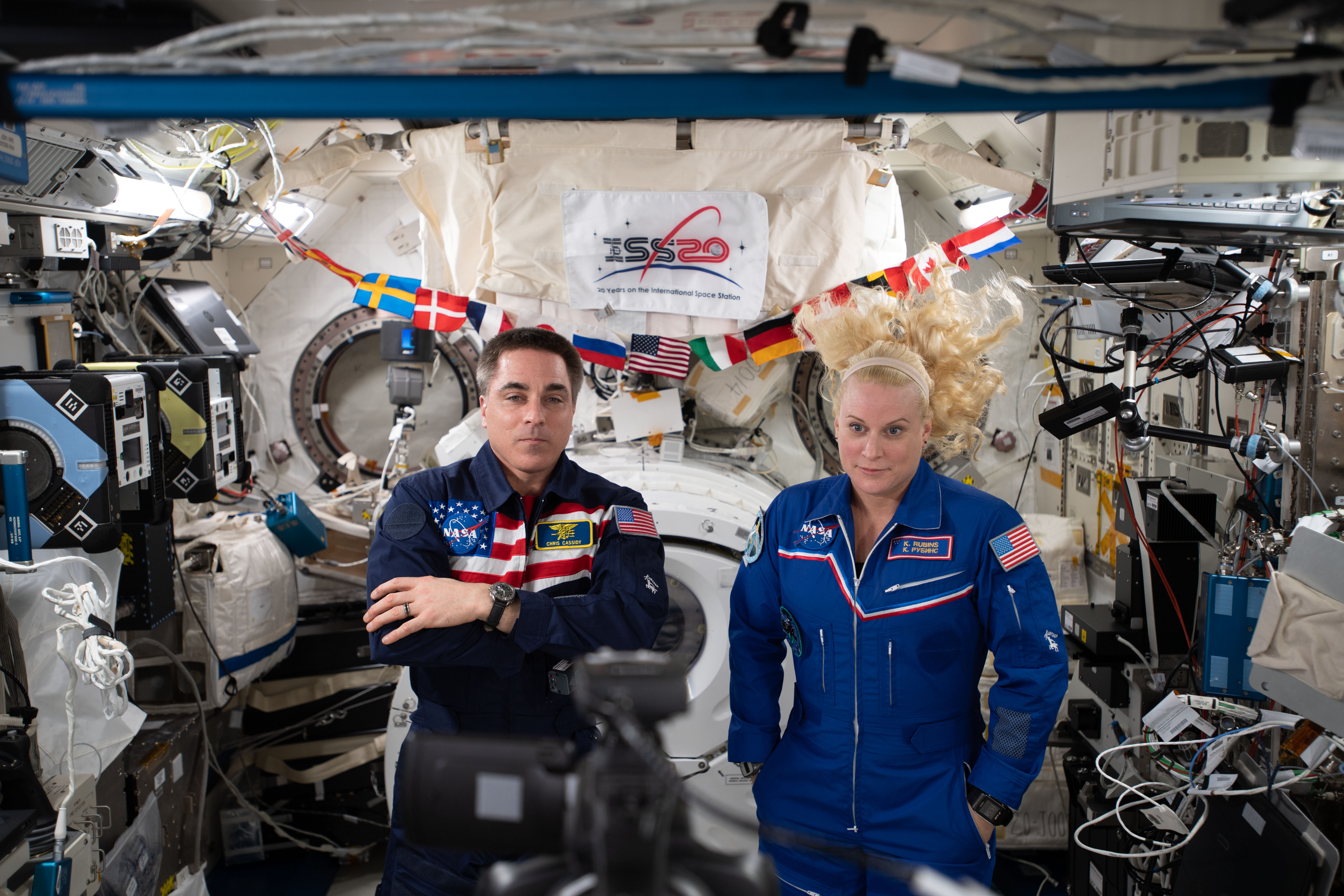 NASA astronauts Chris Cassidy and Kate Rubins are pictured inside the JAXA (Japan Aerospace Exploration Agency) Kibo laboratory module calling down to Earth and talking to former Canadian Space Agency astronaut Julie Payette, now Governor-General of Canada.
