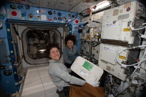 NASA astronauts (from left) Christina Koch and Jessica Meir work inside the Kibo laboratory module collecting cold bags containing biological samples for stowage inside the SpaceX Dragon resupply ship. Dragon parachuted to a splashdown in the Pacific Ocean the following day on Jan. 7, 2020.