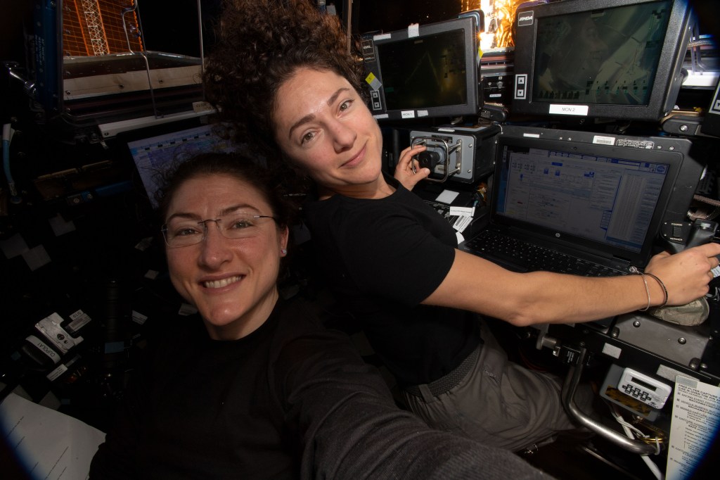 NASA astronauts (from left) Christina Koch and Jessica Meir are inside the cupola practicing the Canadarm2 robotics techniques they would use to capture the Northrop Grumman Cygnus space freighter when it arrived Nov. 4 with more than four tons of science experiments, crew supplies and station hardware.