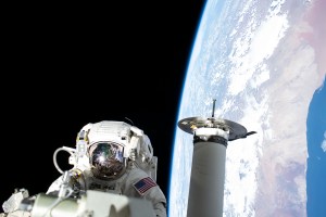 iss068e032186 (Dec. 22, 2022) --- Expedition 68 Flight Engineer and NASA spacewalker Josh Cassada prepares a roll-out solar array for its deployment on the International Space Station's Port-4 truss segment as the orbiting lab flew 262 miles above the Atlantic Ocean off the coast of Namibia.