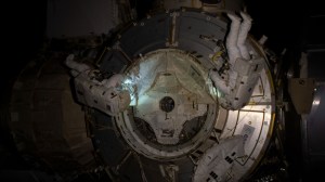 NASA spacewalkers (from left) Bob Behnken and Chris Cassidy set up the outside of the Tranquility module for the future installation of the NanoRacks airlock.