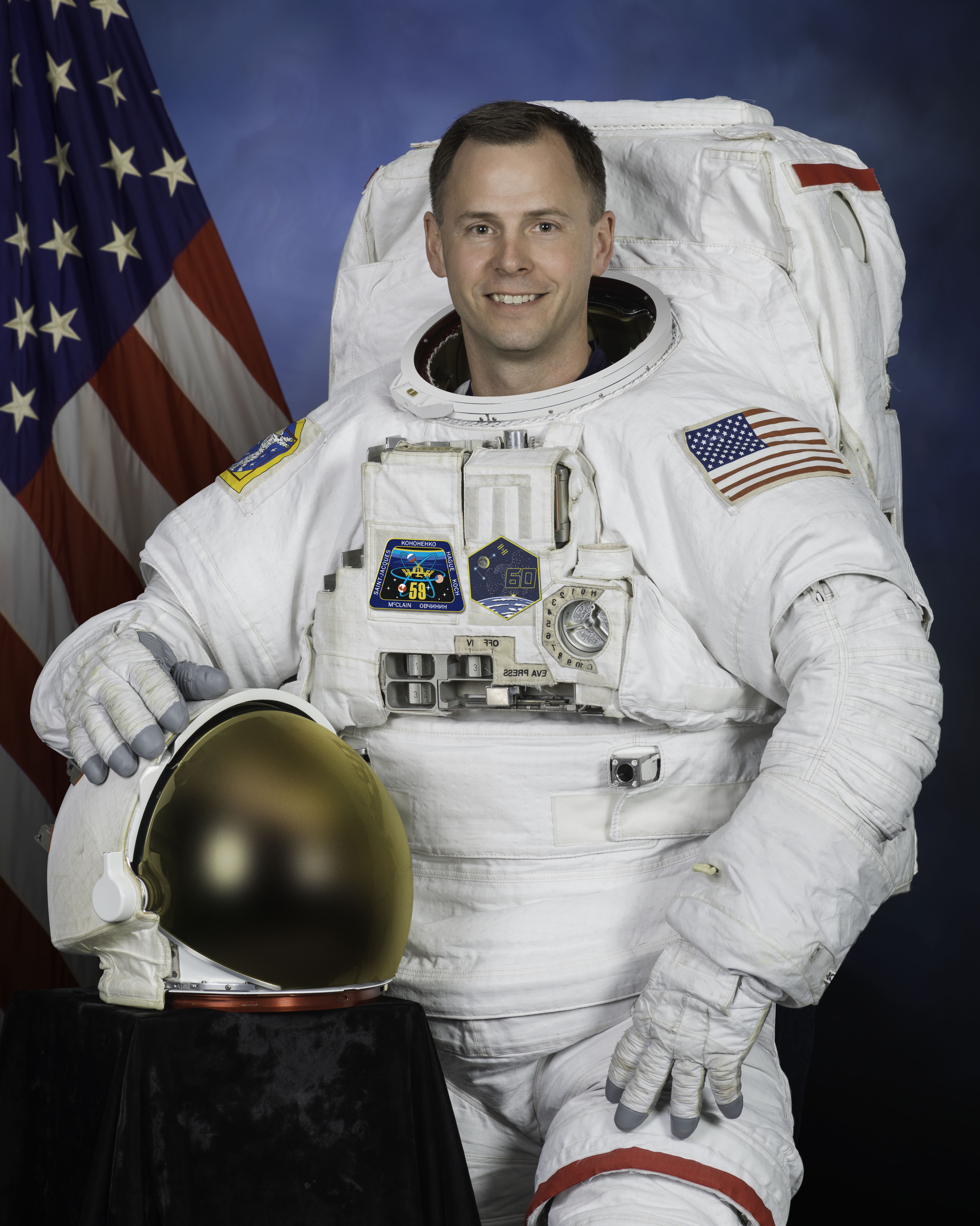 Official portrait of NASA astronaut Nick Hague in a U.S. spacesuit, also known as an Extravehicular Mobility Unit (EMU).