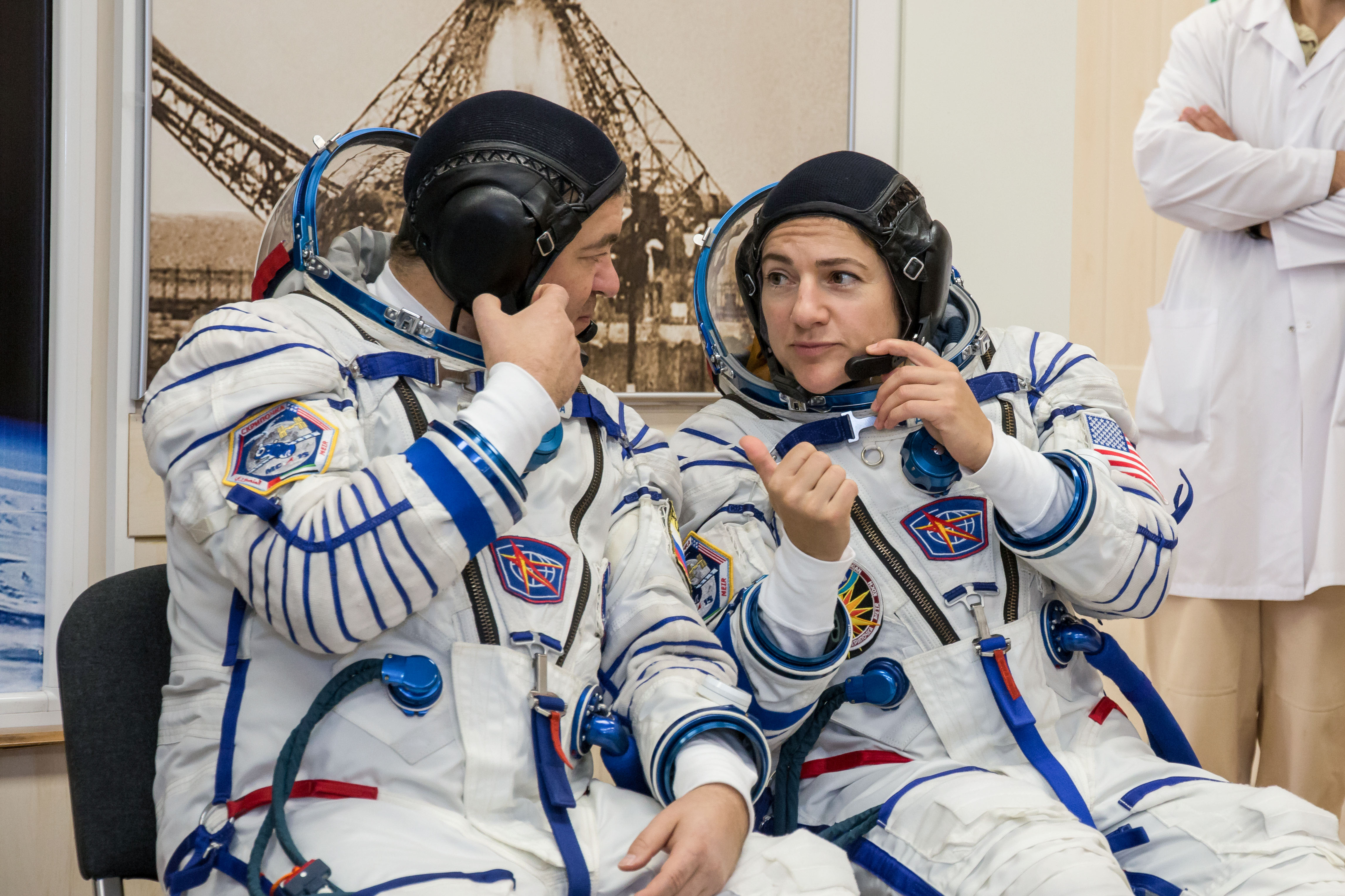 In the Integration Building at the Baikonur Cosmodrome in Kazakhstan, Expedition 61 crewmembers Oleg Skripochka of Roscosmos (left) and Jessica Meir of NASA (right) share some thoughts Sept. 11 during a portion of the initial fit check for their Soyuz MS-15 spacecraft. Along with spaceflight participant Hazzaa Ali Almansoori of the United Arab Emirates, they will launch Sept. 25 on the Soyuz MS-15 spacecraft from the Baikonur Cosmodrome for a mission on the International Space Station.