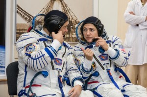 In the Integration Building at the Baikonur Cosmodrome in Kazakhstan, Expedition 61 crewmembers Oleg Skripochka of Roscosmos (left) and Jessica Meir of NASA (right) share some thoughts Sept. 11 during a portion of the initial fit check for their Soyuz MS-15 spacecraft. Along with spaceflight participant Hazzaa Ali Almansoori of the United Arab Emirates, they will launch Sept. 25 on the Soyuz MS-15 spacecraft from the Baikonur Cosmodrome for a mission on the International Space Station.