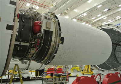 Workers integrate the Cygnus mass simulator with its Antares launch vehicle