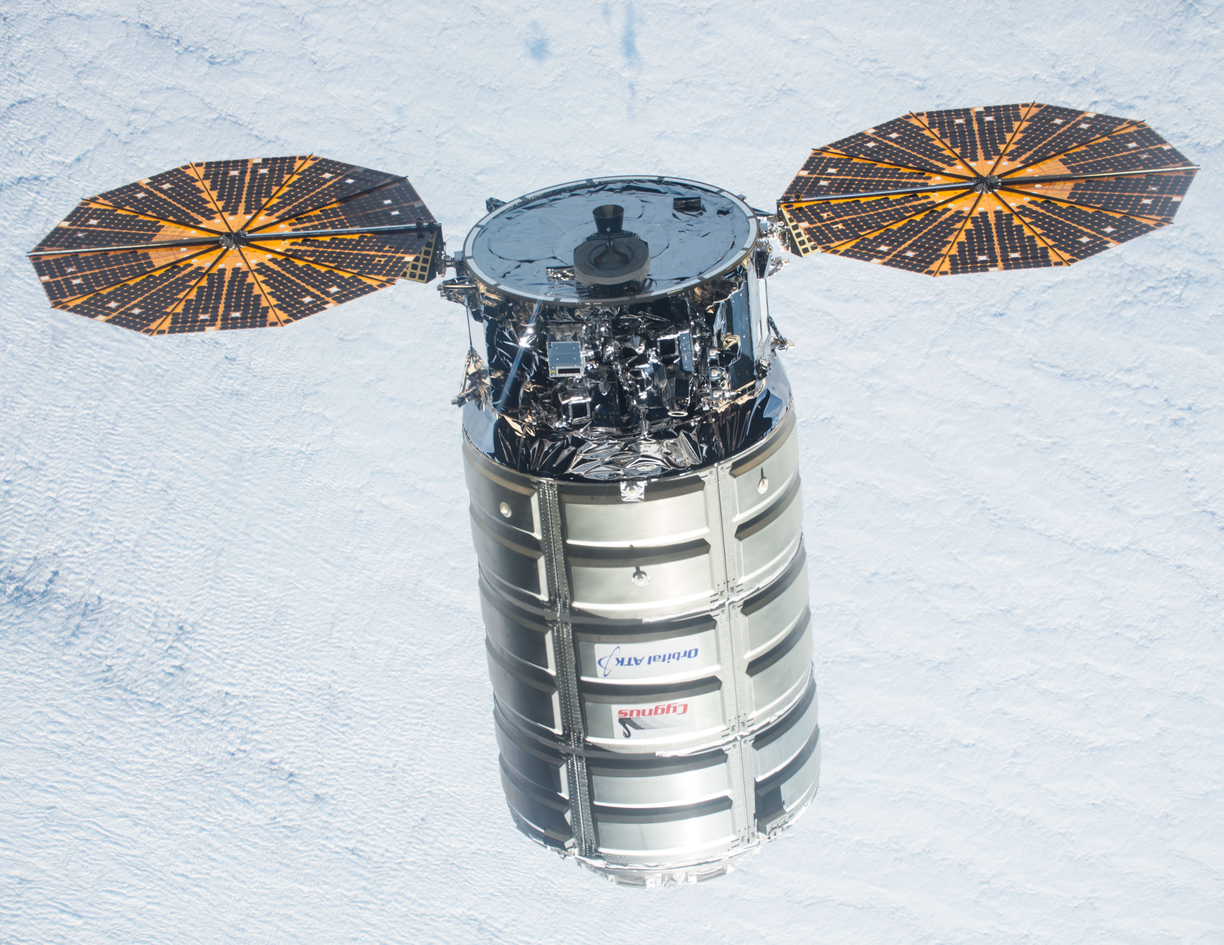 The first Enhanced Cygnus arriving at the space station in 2015; compare against the smaller standard Cygnus